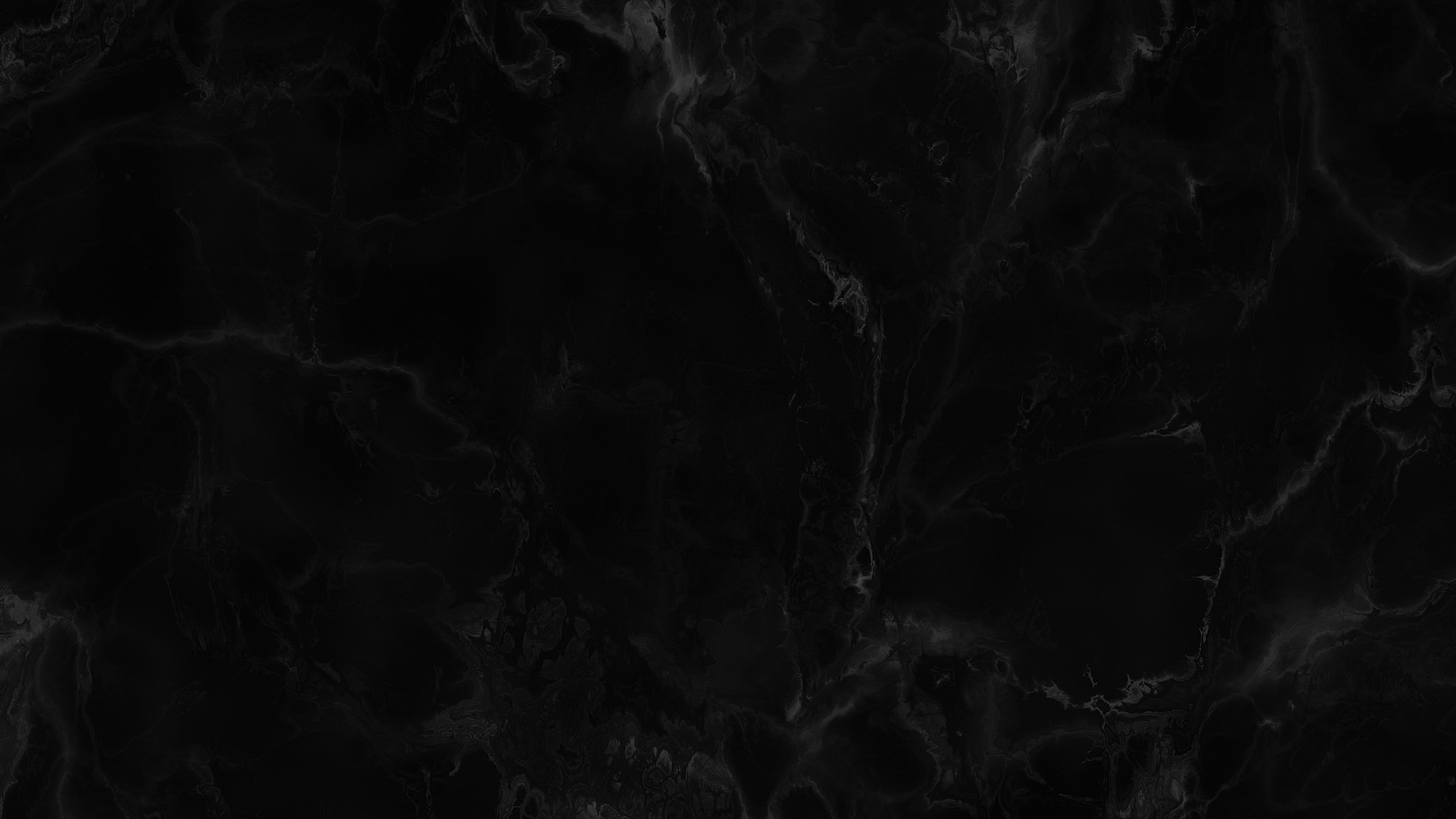 Black marble texture background with subtle patterns.