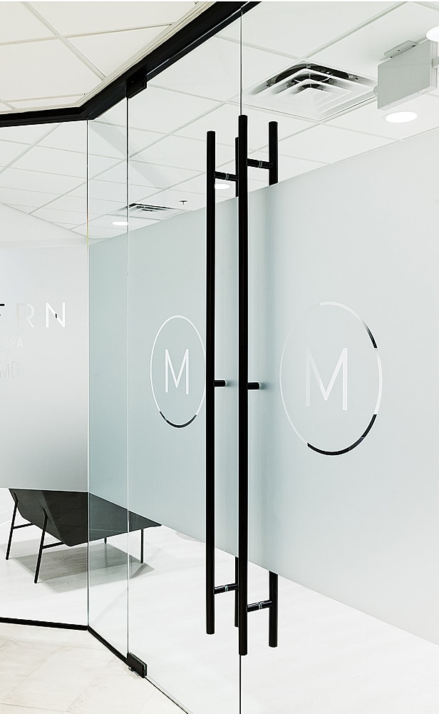 Modern office entrance with glass door design.