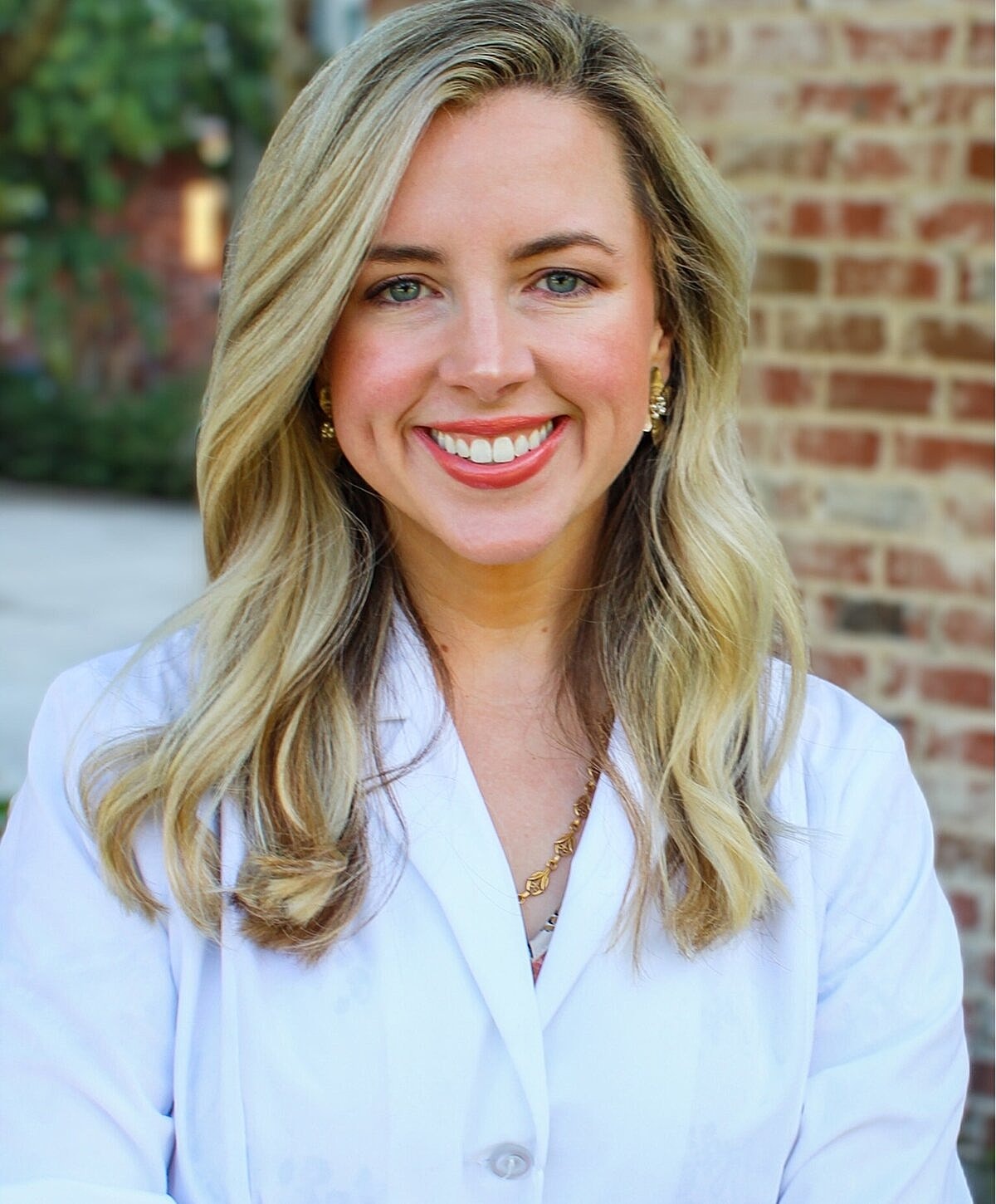 Smiling man in blue suit with pocket square.