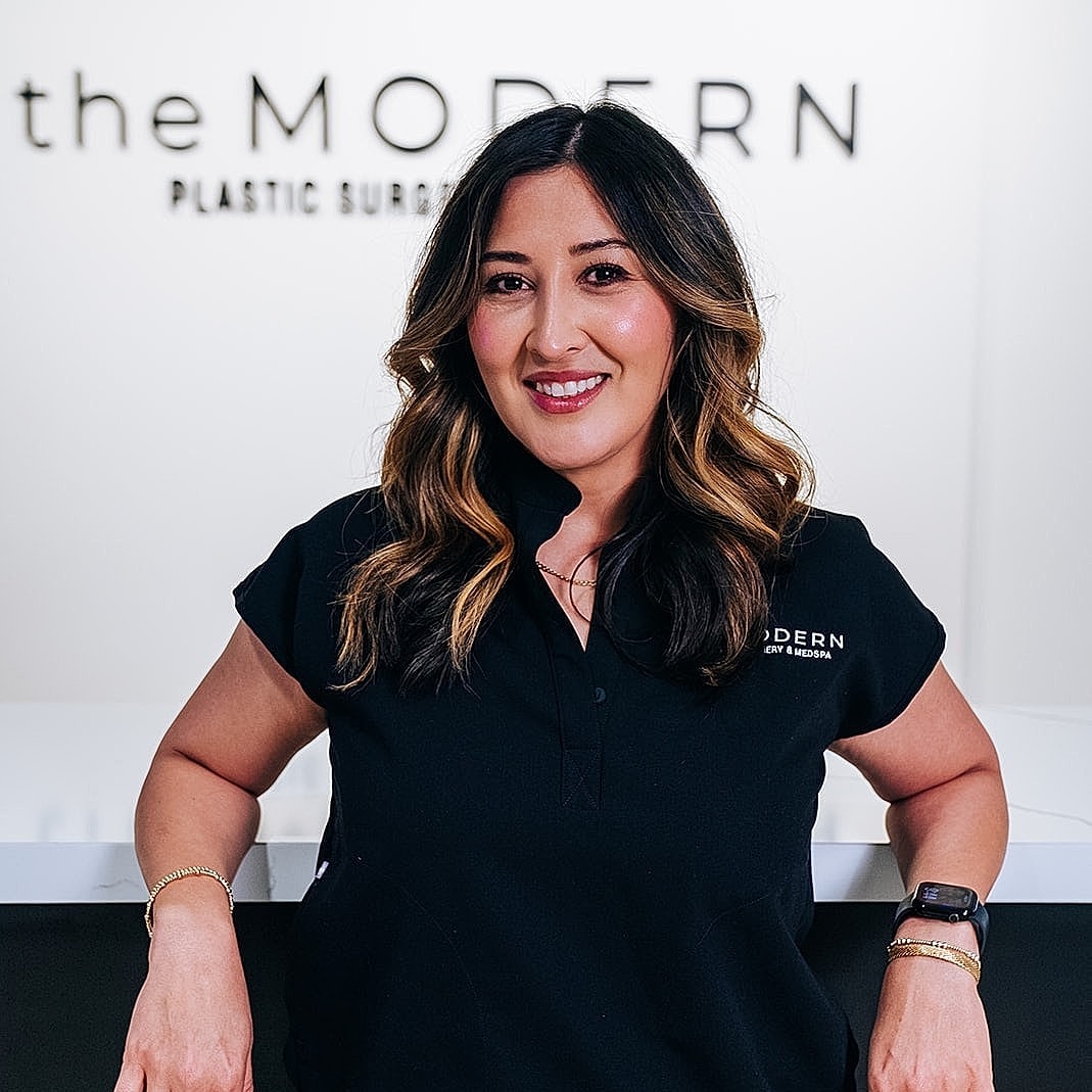 Woman smiling in plastic surgery clinic setting