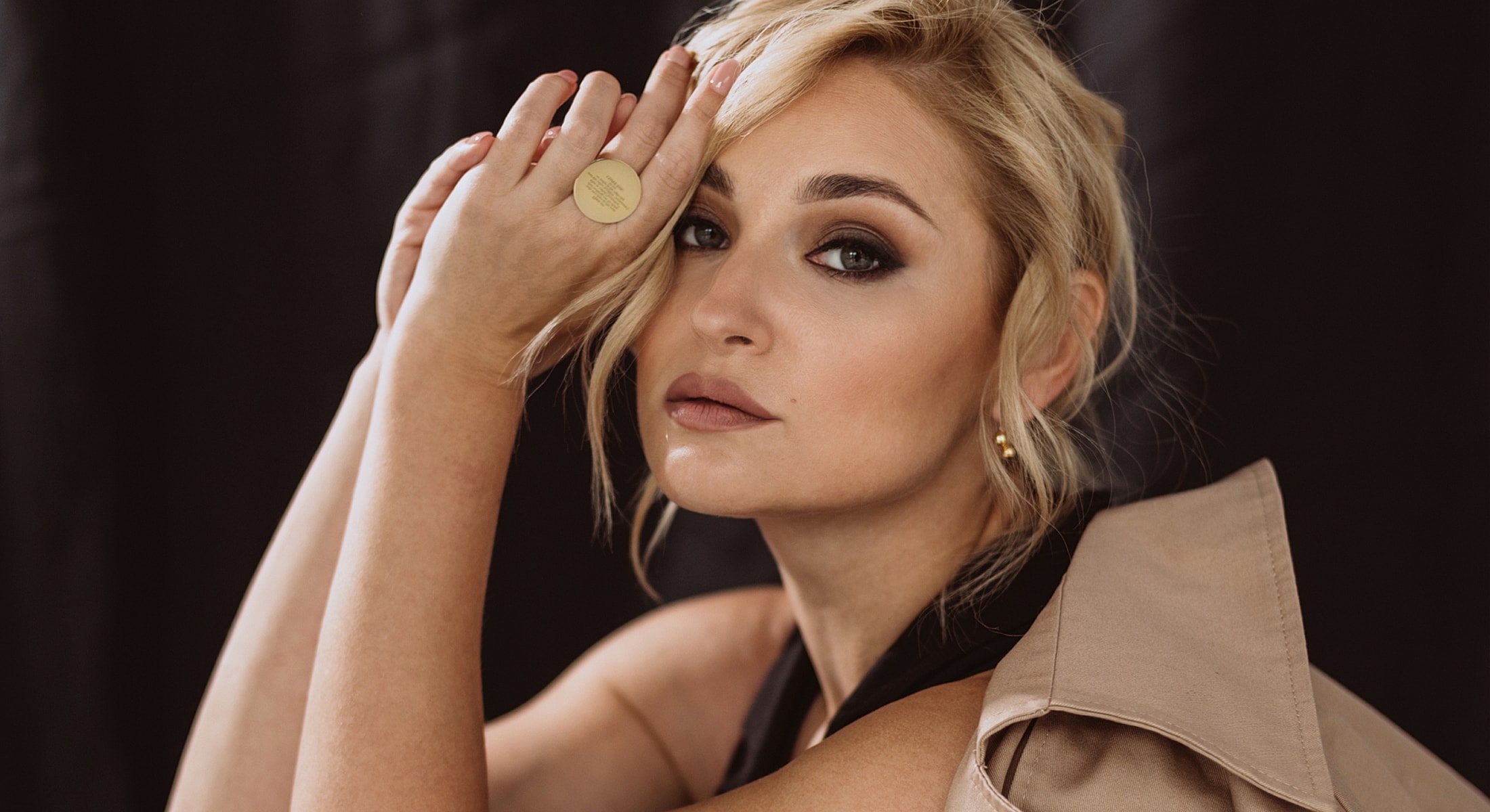 Woman with glamorous makeup and stylish attire.