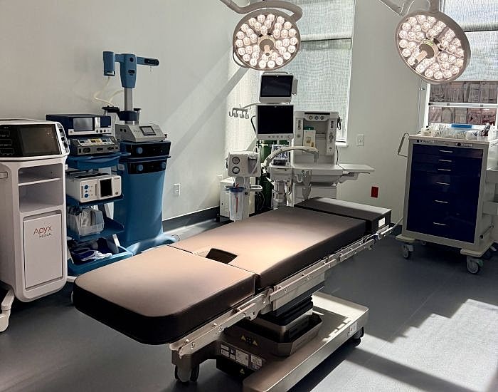 Operating room with surgical equipment and table.