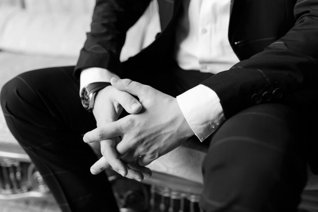 Man sitting with his hands crossed.