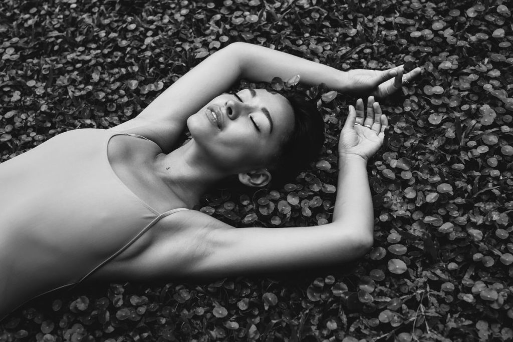 Young beautiful woman with tropical plants