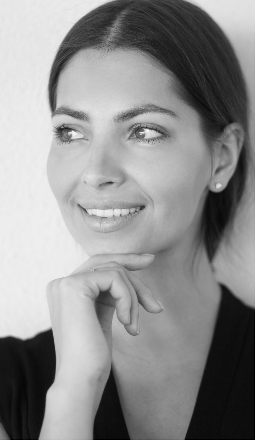 Woman smiling resting head on hand